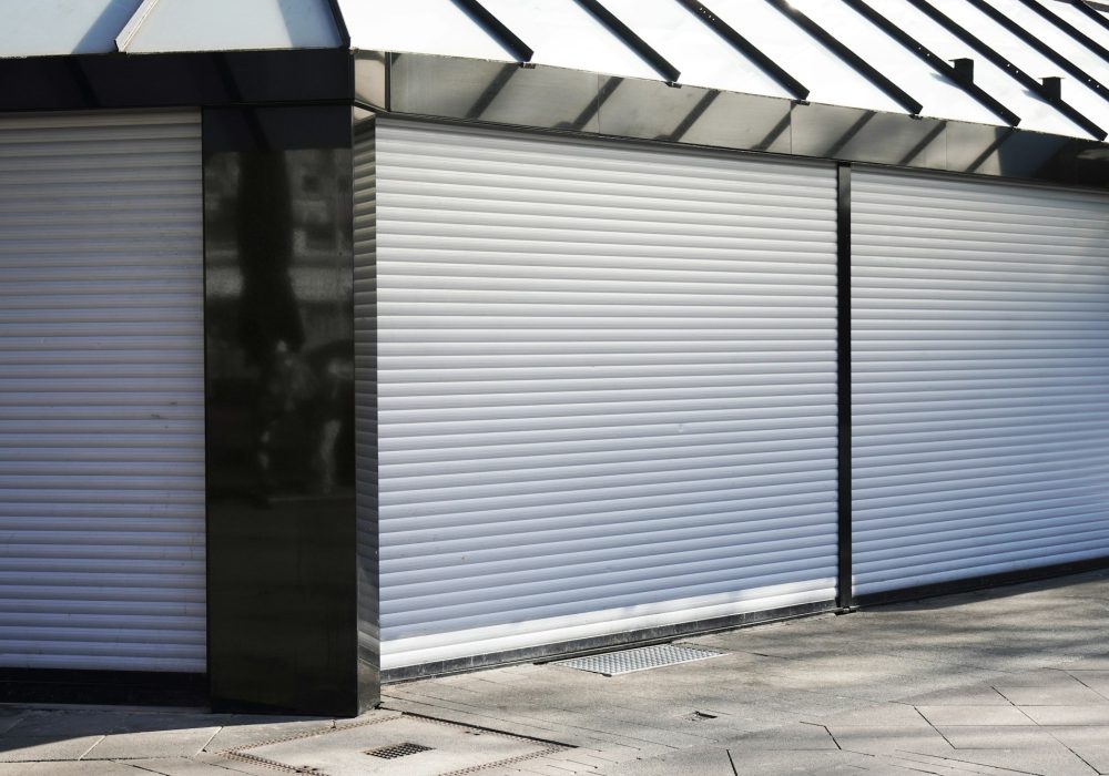 closed business shop or store front with roller shutters. economy crisis and recession concept.